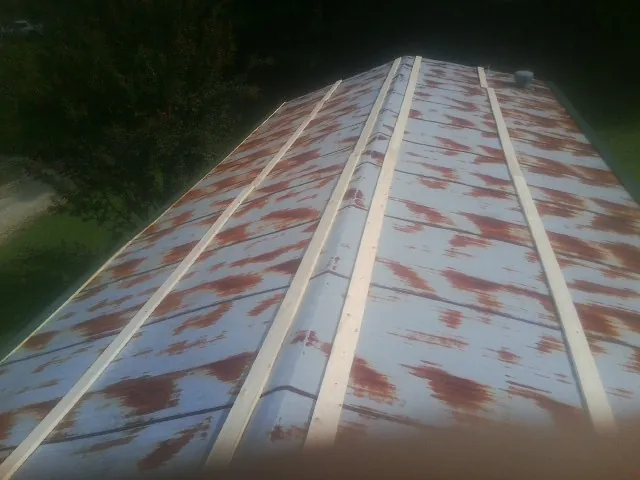 Rusted metal roof panels with new wood purlins before replacement — Storm Damage Roof Repair in Mentone by Roofing Brothers