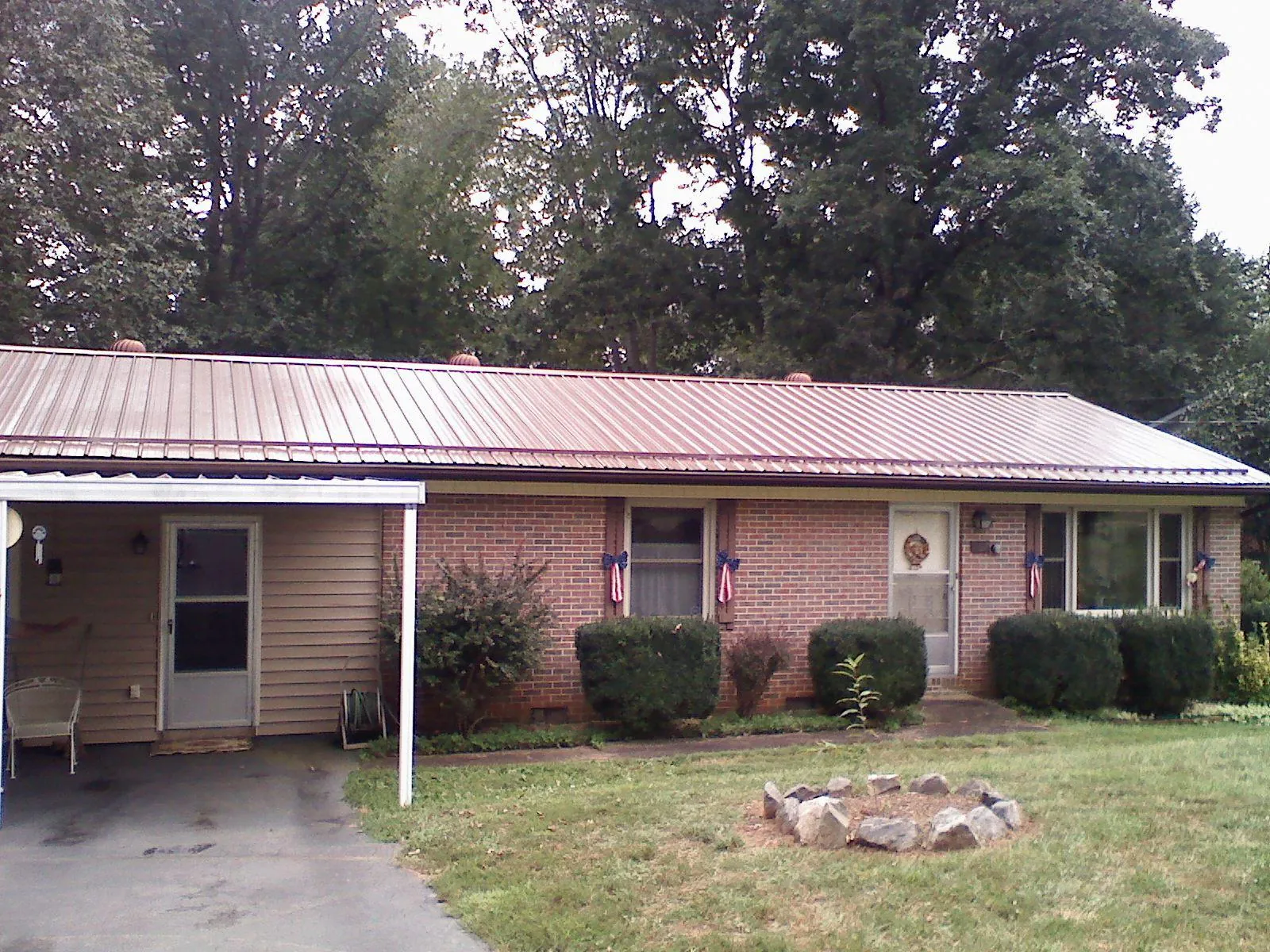 Bronze metal roof and carport on a brick ranch home — Roof Repair work by our crew in Mentone
